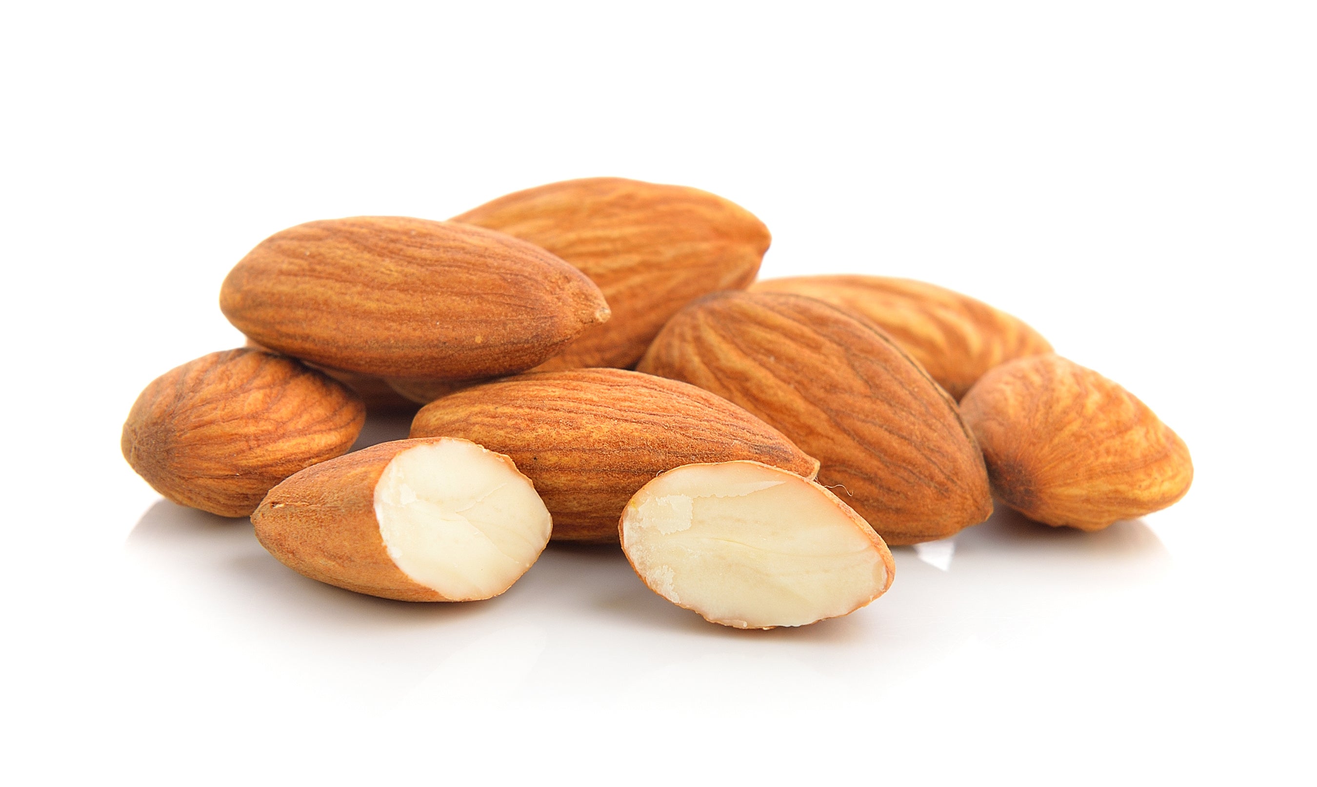 Almonds arranged in a pile, with their hard, light brown shells cracked open to reveal the creamy, off-white nut inside