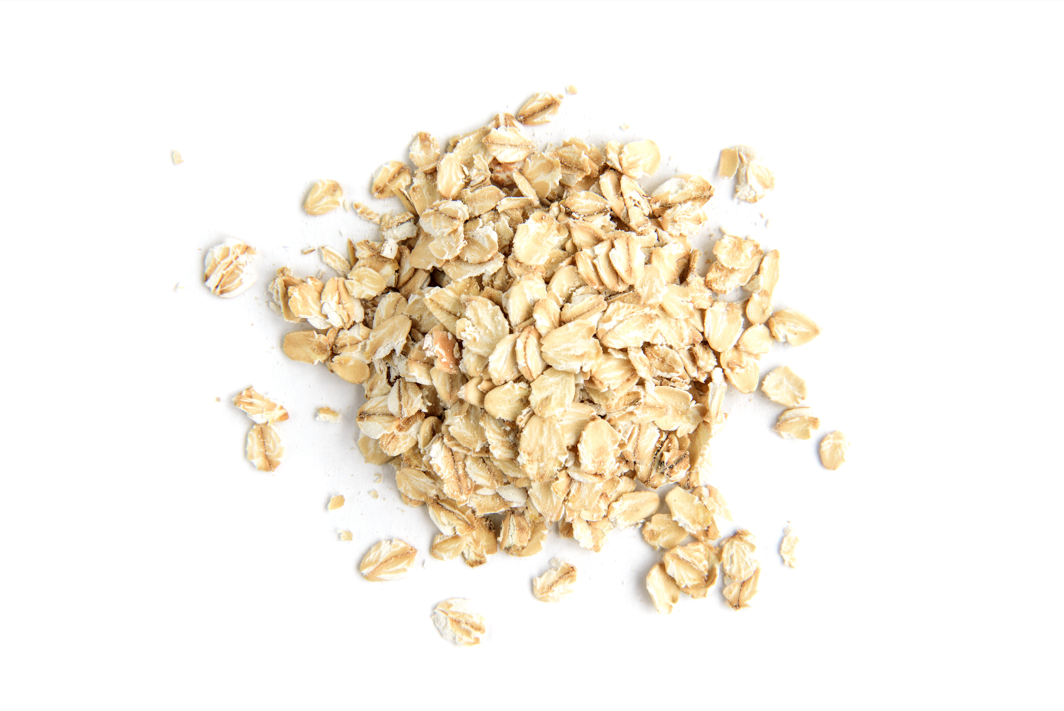 pile of whole rolled oats on a white background