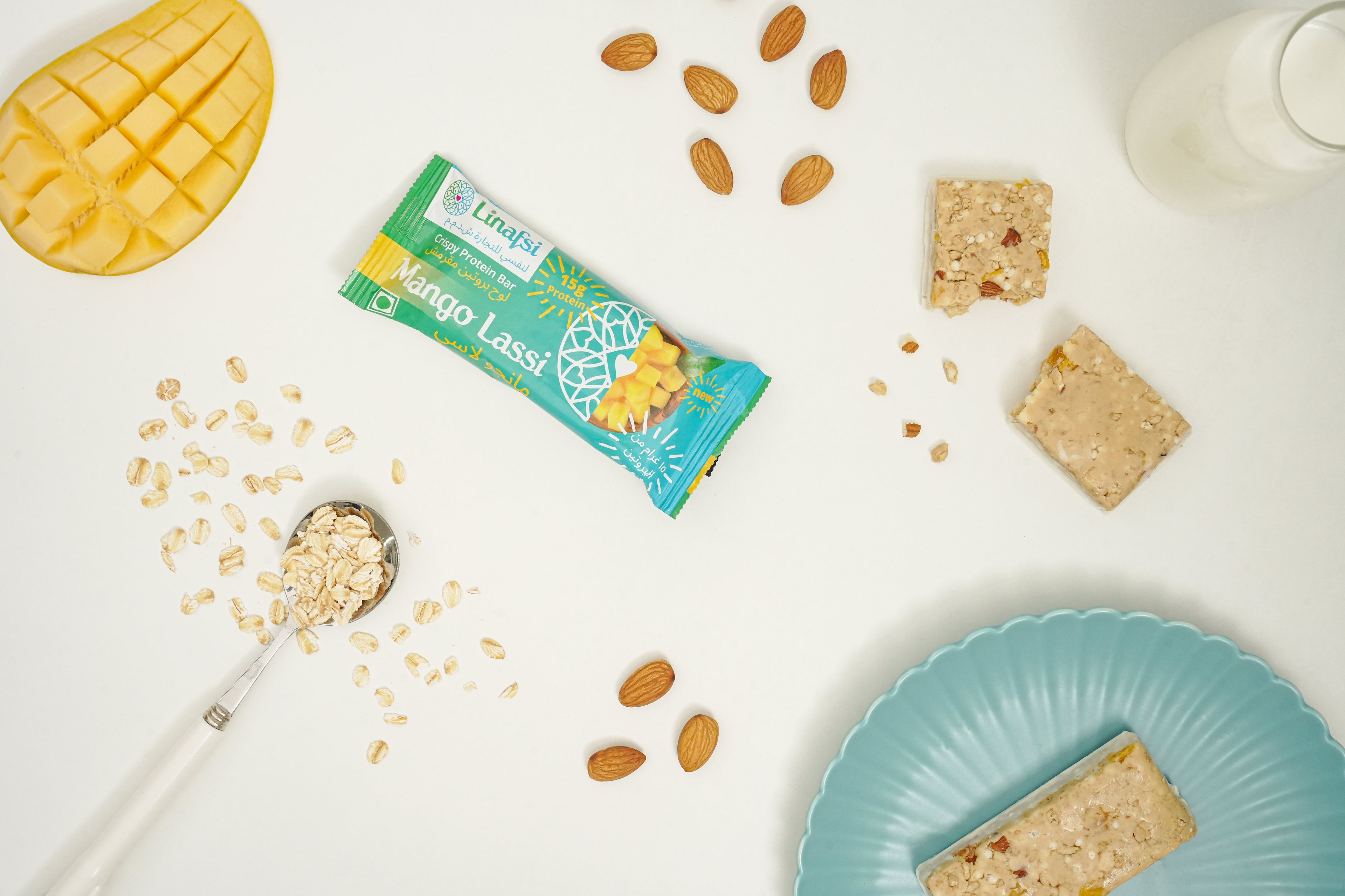 Overhead shot of mango lassi protein bars with ingredients: mango fruit, rolled oats, and almonds. 